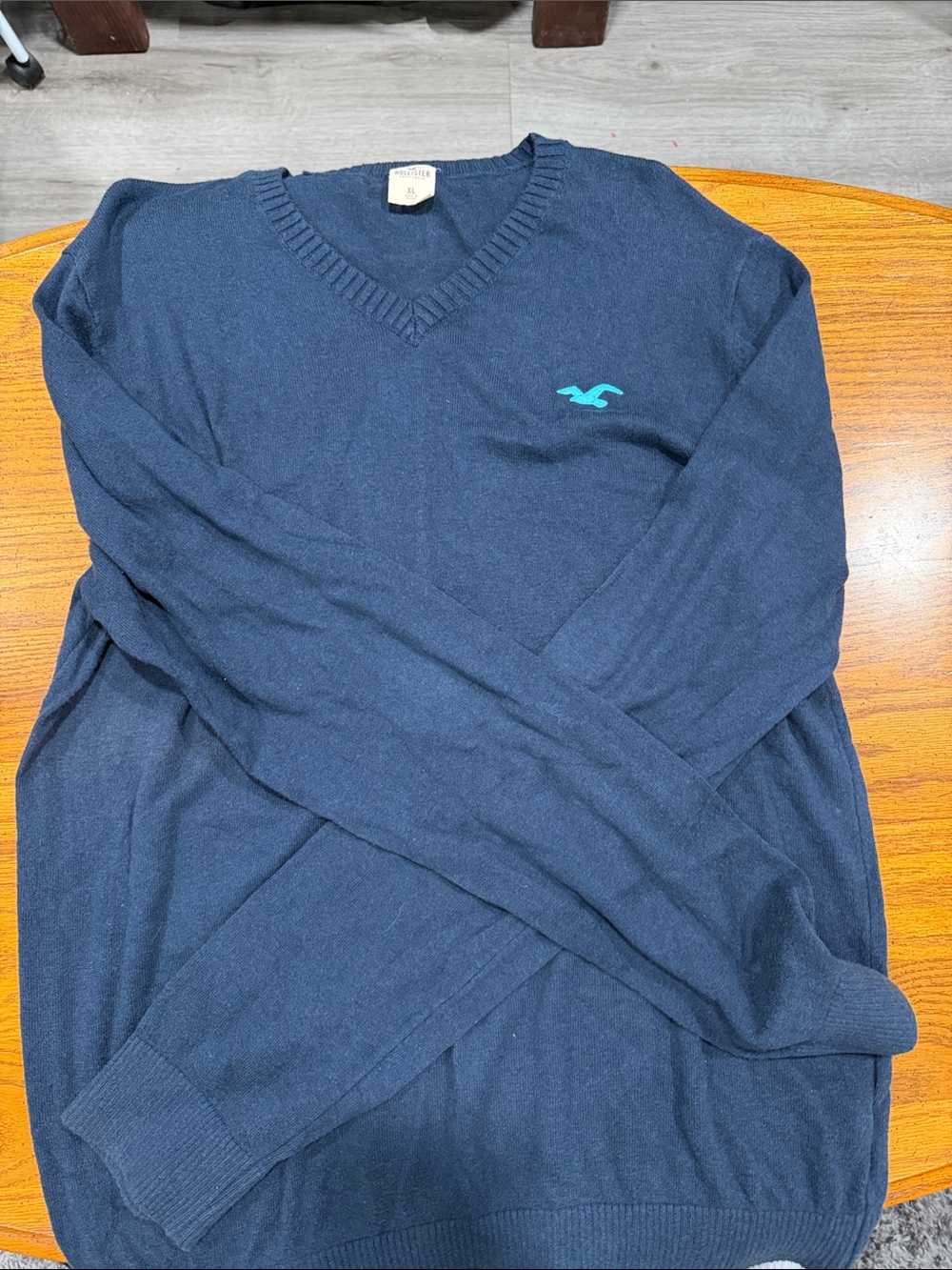 Hollister Men's Dark Blue V-Neck Sweater with Teal Logo